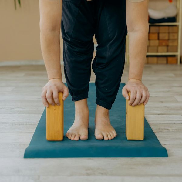 Person doing a gentle stretching exercise on a yoga mat.
